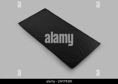 Mockup of a black terry towel for design, branding. Template of fluffy towelette for wiping the body, isolated on background. Unfolded fabric with lab Stock Photo