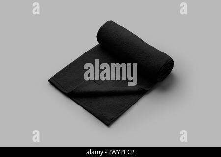 Template of a black terry towel with a label, rolled for advertising, branding, product presentation. Soft fabric, toiletries for hotel, spa, sauna. F Stock Photo