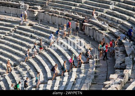 EPIDAURUS, GREECE - SEPTEMBER 20, 2012: A group of unidentified tourists ascends the steps of the ancient Greek theater. Stock Photo