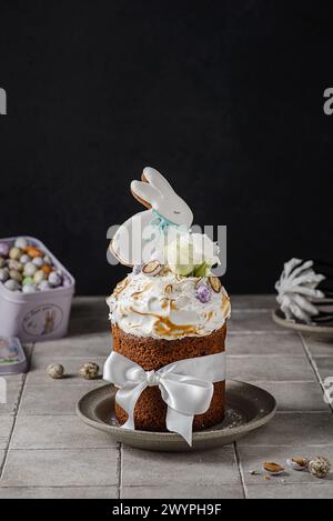 Easter cake on a dark background decorated with Easter chocolate eggs and Easter gingerbread rabbit Stock Photo
