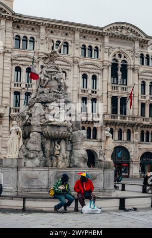 Trieste Italy - 30 march 2024: Fountain of the Four Continents on the Piazza Unita d'Italia with unknown people, Trieste. Stock Photo