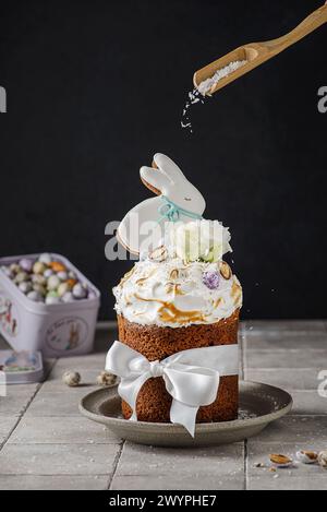 Easter cake on a dark background decorated with Easter chocolate eggs and Easter gingerbread rabbit Stock Photo