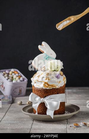 Easter cake on a dark background decorated with Easter chocolate eggs and Easter gingerbread rabbit Stock Photo