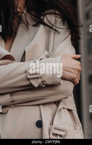 Street style fancy details of a beige women's trench coat with belt ...