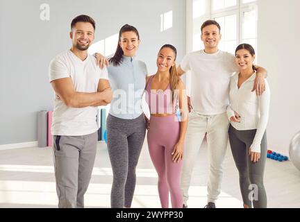Smiling Team Of Athletes In Gym After Fitness Training Stock Photo
