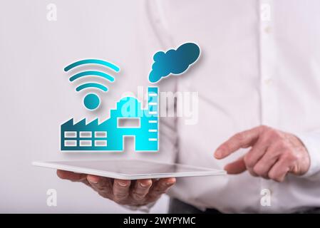 Industry 4.0 concept above a tablet held by a man in background Stock Photo