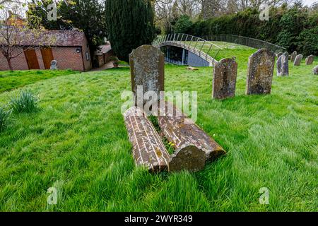 Rare brick barrel graves in the churchyard of St Mary's Church in Chiddingfold, a village in Surrey, south-east England Stock Photo