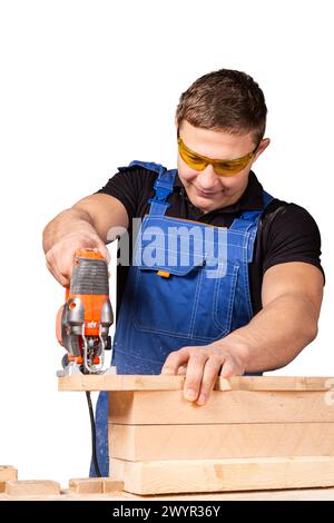 A carpenter using a jigsaw to cut wood cuts bars on white background Stock Photo