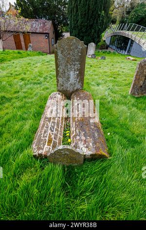 Rare brick barrel graves in the churchyard of St Mary's Church in Chiddingfold, a village in Surrey, south-east England Stock Photo