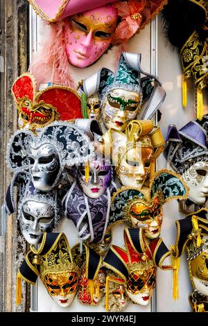 Traditional carnival masks on display in a shop for sale as typical tourist souvenirs in a shop in the Castello area of Venice, Italy Stock Photo