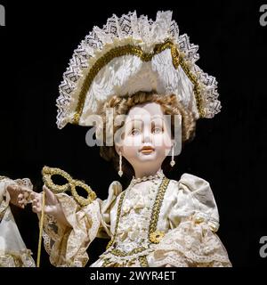 Head of a traditionally lace dressed doll on display in a shop for sale as typical tourist souvenirs in a shop in the Castello area of Venice, Italy Stock Photo