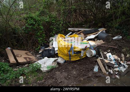 Harefield, UK. 8th April, 2024. Ilegal fly-tipping on a country road in Harefield, Uxbridge despite being just near to fly-tipping warning signs and CCTV surveillance that tell people they could be fined up to £20,000 for fly-tipping. Credit: Maureen McLean/Alamy Live News Stock Photo