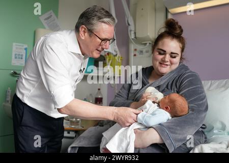 Labour leader Sir Keir Starmer, meets Casey Westwood and her baby Ralphie, during a visit to Kings Mill Hospital Sutton-in-Ashfield, in the East Midlands, as he unveils Labour's plans to digitise the 'red book' of children's health records. Picture date: Monday April 8, 2024. Stock Photo