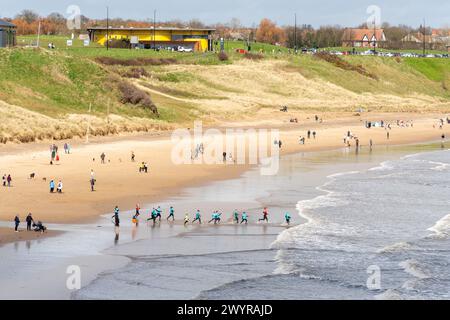 People enjoying Longsands or Long sands beach in Tynemouth, North Tyneside, UK. England beach holiday or vacation concept. Stock Photo