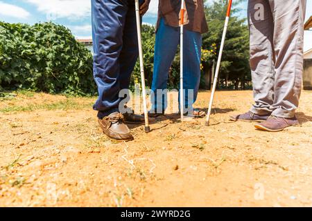 Close up of the feet of three blind people using the cane to walk. Stock Photo