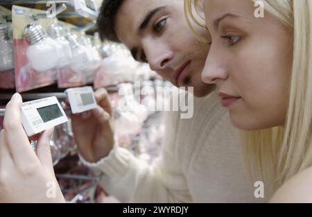 Couple looking at electronic price displays at Eroski shopping center. These displays are updated by remote control. Urbil. Usurbil. Guipuzcoa. Basque Country. Spain. Stock Photo