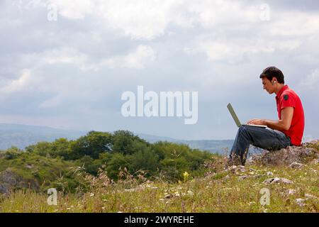 Young man using laptop computer, Murguia, Alava, Euskadi, Spain. Stock Photo