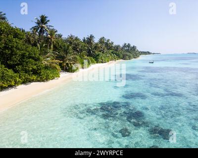 Aerial view of the Dhigurah island in the Maldives famous for its long white sand beach lined with palm trees in the south Ari atoll Stock Photo