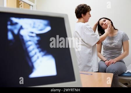 Doctor checking neck tilt, Cervical X-ray image, Physiotherapy medical center, Donostia, San Sebastian, Gipuzkoa, Basque Country, Spain. Stock Photo