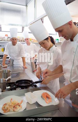 Sauteing prawns y salmon. Luis Irizar cooking school. Donostia, Gipuzkoa, Basque Country, Spain. Stock Photo