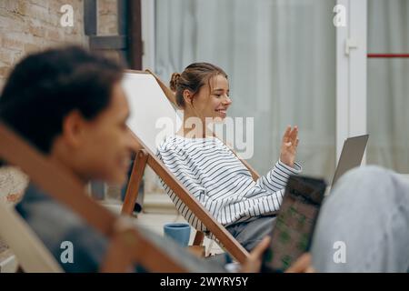 Young female freelancers sitting in coworking terrace while working on digital tablet and laptop Stock Photo
