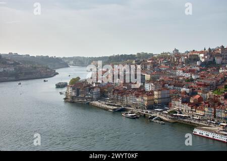 Douro river and local houses with orange roofs in Porto city aerial panoramic view. Porto is the second largest city in Portugal. Stock Photo