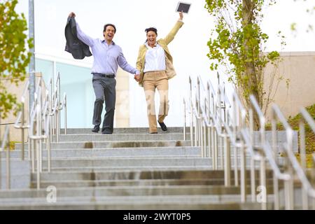 Business couple jumping stairs. San Sebastian Technology Park. Donostia. Gipuzkoa. Basque Country. Spain. Stock Photo