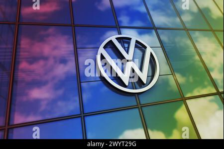 Wolfsburg, Germany, April 2, 2024: Volkswagen car producer headquarters glass building concept. Automobile manufacturer company symbol logo on front f Stock Photo