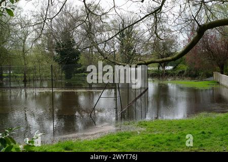 Harefield, UK. 8th April, 2024. Flooding in a garden and tennis courts next to the Grand Union Canal towpath in Harefield, Uxbridge. Credit: Maureen McLean/Alamy Live News Stock Photo