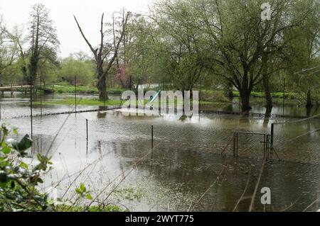 Harefield, UK. 8th April, 2024. Flooding in a garden and tennis courts next to the Grand Union Canal towpath in Harefield, Uxbridge. Credit: Maureen McLean/Alamy Live News Stock Photo