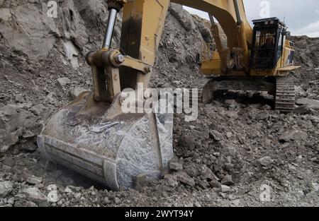 Extracting raw material from quarry for cement manufacturing. Stock Photo