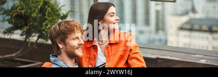 A man and a woman sit closely together on a park bench, engaging in deep conversation as they gaze into each others eyes Stock Photo