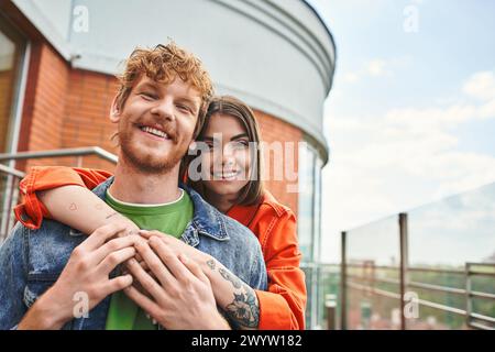 A man tenderly holds a woman in his arms, showing a gesture of care and affection in a serene setting Stock Photo
