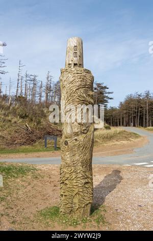 Wooden artwork, lighthouse, LLanddwyn Bay, Newborough, Anglesey Island, Wales, Great Britain Stock Photo