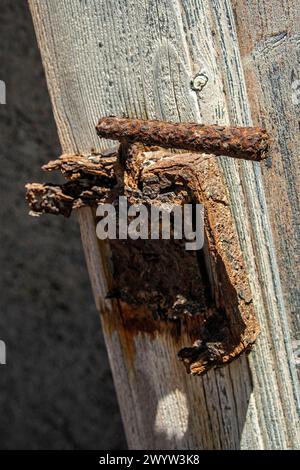 heavily rusted door lock and handle in an abandoned mine house in Bogenfels, Namibia. Stock Photo