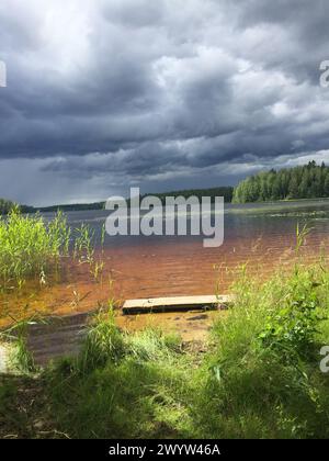Dark clouds over a summer lake in Finland Stock Photo