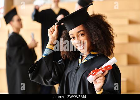 A diverse group of graduates joyfully celebrate in their caps and gowns at a university graduation ceremony. Stock Photo