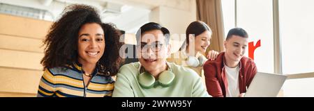 Multicultural group of women sitting together, working on a laptop computer Stock Photo