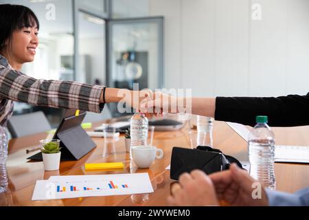 Two business partners shaking hands during a meeting in the office Stock Photo