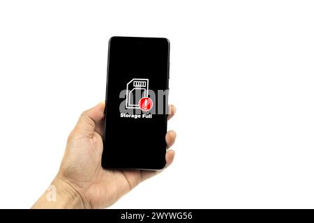 Cellular Problems Concepts. Man hand holding smart phone with full storage icon on screen isolated on white background. All screen graphics are made u Stock Photo