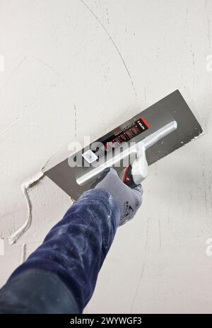 Rendering wall using trowel, new homes under construction, construction site. Stock Photo