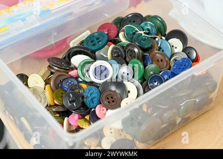 The buttons are of various sizes, shapes, and colors. They are made from different materials, including plastic, wood, and metal. Also, some buttons h Stock Photo