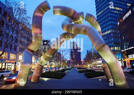 The Kaiser Wilhelm Gedächtniskirche, Emperor Wilhelm Memorial church, in front sculpture called Berlin by Brigitte Matschinsky-Denninghoff and Martin Denninghoff, Tauentzienstraße, Kurfürstendamm, Berlin, Germany. Stock Photo