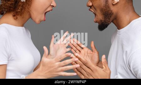 Young couple yelling at each other in studio Stock Photo