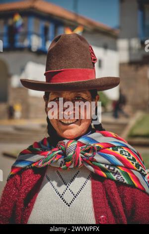 Cusco, Peru - March 2024. Portrait Peruvian woman wearing national clothing posing with llama near Cusco Peru. Stock Photo