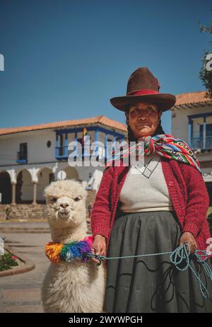Cusco, Peru - March 2024. Native Peruvian women in Cusco dressed up in traditional colorful clothing with a llama, Cusco Peru. Stock Photo