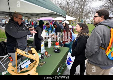 A vendor explains how an eclipse occurs to a visiting couple at Niagara Falls, New York on Monday April 8, 2024. Upstate New York, is one of the many US States which will fall under the path of the moon's shadow as it races to the northeast from Texas through to Maine on April 8. Photo by Joe Marino/UPI Credit: UPI/Alamy Live News Stock Photo