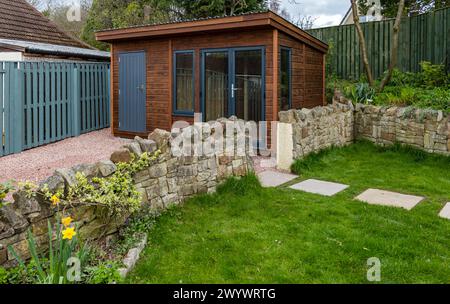 A shed and garden room or summerhouse newly built in a driveway, Scotland, UK Stock Photo