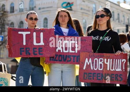 Ukrainian women posing with a banner 'Free Azovstal Defenders' on a public rally in Ukraine dedicated to captured Azov brigade fighters. Kyiv - 7 April,2024 Stock Photo