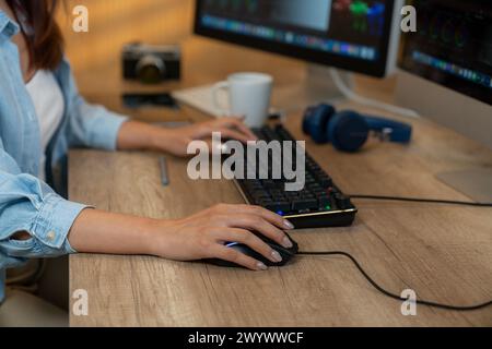 The hands of the young woman who is working with a mouse and keyboard computer Stock Photo